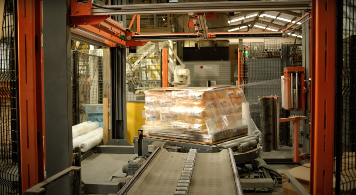 A wrapped pallet leaving the PHS turntable wrapper on the outfeed conveyor